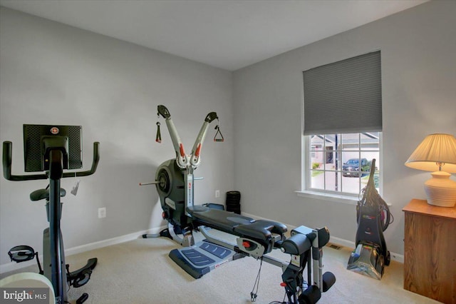 workout room with baseboards and carpet