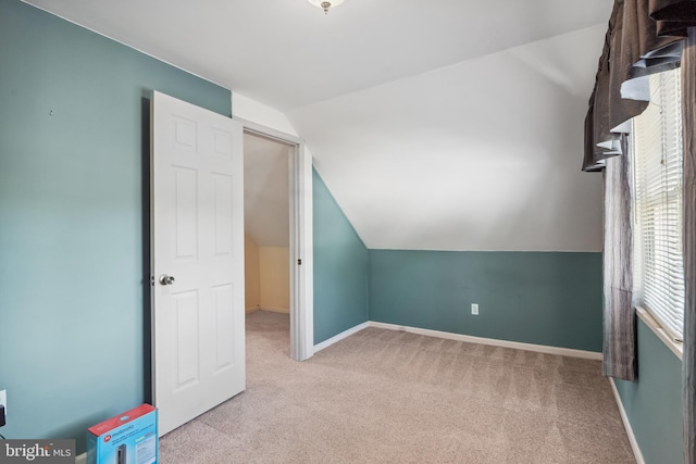bonus room featuring carpet floors, baseboards, and lofted ceiling