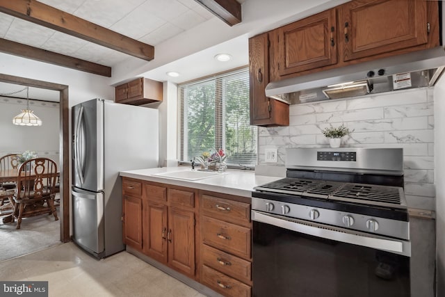 kitchen with a sink, stainless steel appliances, backsplash, under cabinet range hood, and beamed ceiling