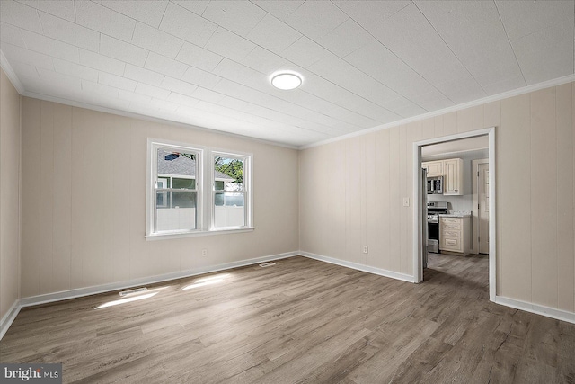 2708 Old Ocean City Rd, Salisbury, MD 21804 - unfurnished room featuring ornamental molding, wood finished floors, baseboards, and wooden walls
