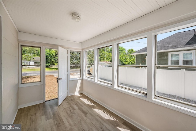 2708 Old Ocean City Rd, Salisbury, MD 21804 - unfurnished sunroom with baseboards, plenty of natural light, and wood finished floors
