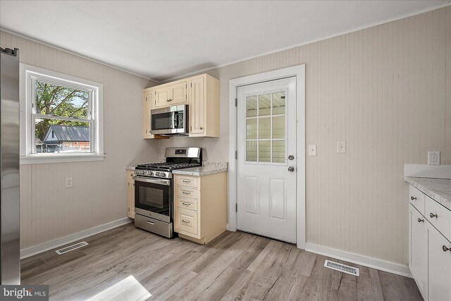 2708 Old Ocean City Rd, Salisbury, MD 21804 - kitchen featuring stainless steel appliances, baseboards, light wood-style floors, and ornamental molding