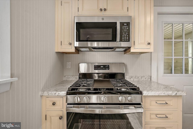 2708 Old Ocean City Rd, Salisbury, MD 21804 - kitchen featuring stainless steel appliances, cream cabinetry, and light stone countertops