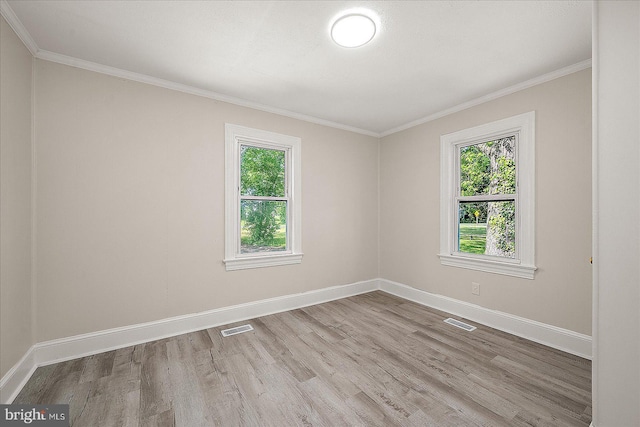 2708 Old Ocean City Rd, Salisbury, MD 21804 - empty room with healthy amount of natural light, wood finished floors, baseboards, and crown molding