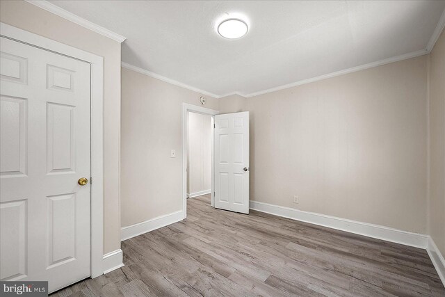 2708 Old Ocean City Rd, Salisbury, MD 21804 - unfurnished bedroom with wood finished floors, baseboards, and ornamental molding