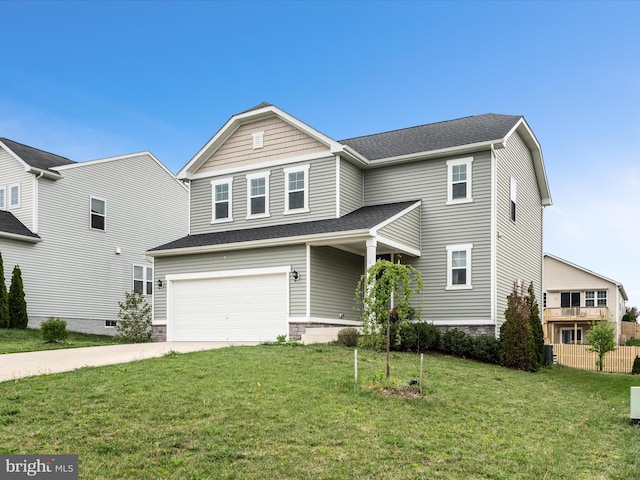 traditional home with a front lawn, fence, a shingled roof, concrete driveway, and an attached garage