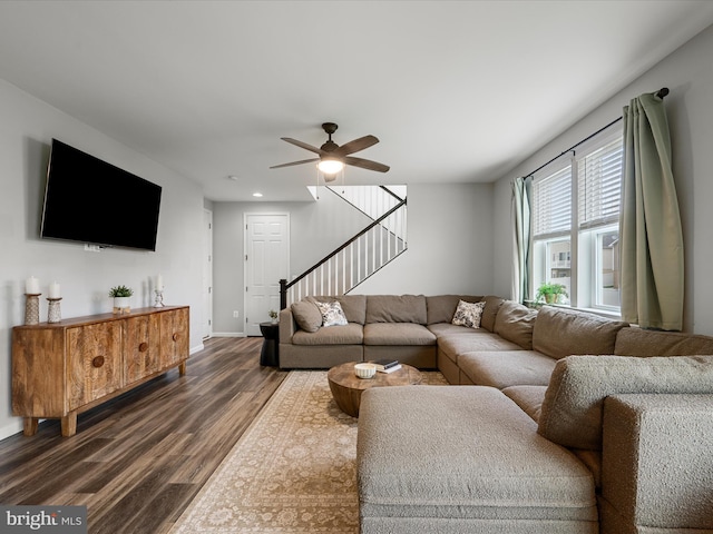 living area featuring dark wood-style flooring, baseboards, ceiling fan, stairway, and recessed lighting