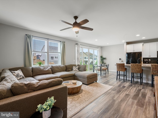 living room featuring recessed lighting, wood finished floors, and a wealth of natural light