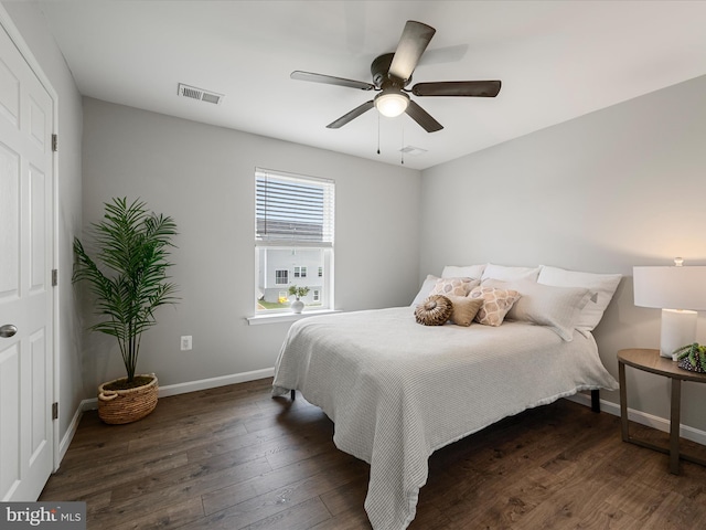 bedroom with visible vents, a ceiling fan, baseboards, and hardwood / wood-style floors