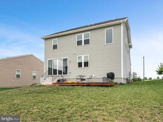 rear view of property featuring a yard