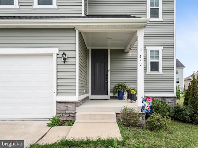view of exterior entry with an attached garage