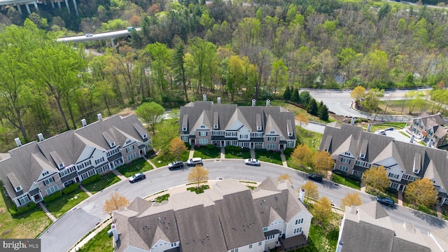birds eye view of property with a residential view and a wooded view