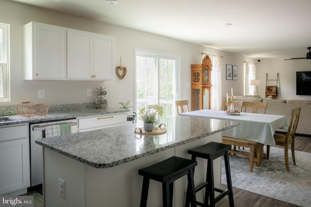 300 Coville St, Middletown, VA 22645 - kitchen featuring open floor plan, a kitchen breakfast bar, white cabinetry, light stone counters, and dishwasher