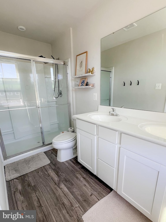 300 Coville St, Middletown, VA 22645 - bathroom with double vanity, visible vents, a shower stall, wood finished floors, and a sink