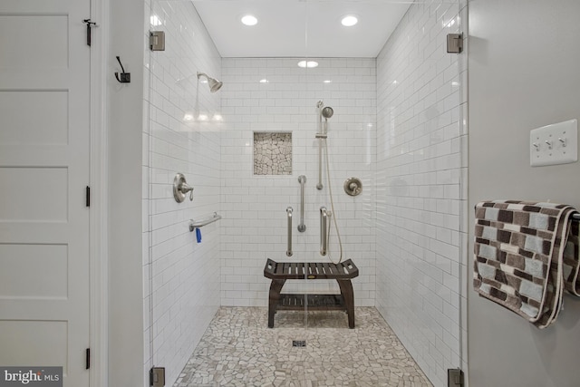 bathroom with a stall shower and recessed lighting