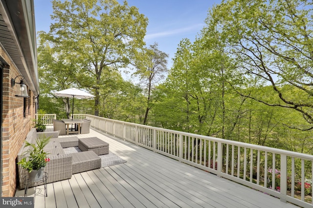 wooden terrace featuring an outdoor hangout area and outdoor dining space
