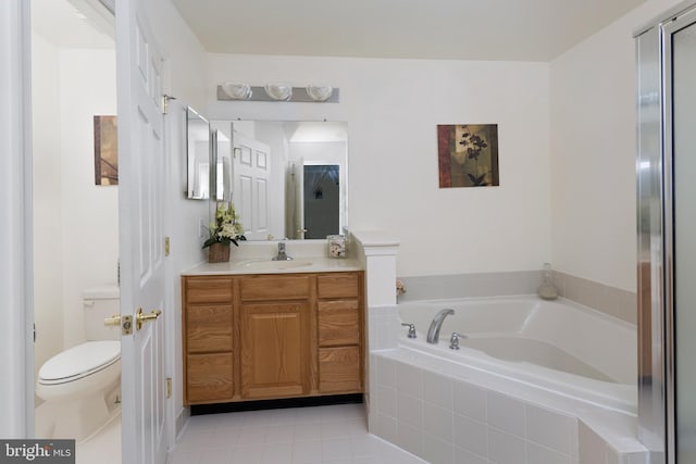 bathroom featuring vanity, tile patterned flooring, a garden tub, and toilet