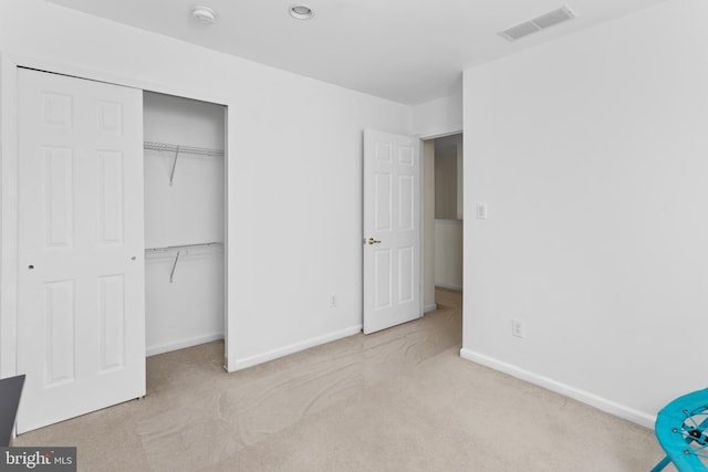 unfurnished bedroom featuring a closet, baseboards, carpet flooring, and visible vents