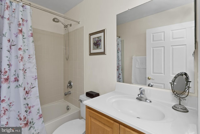 bathroom featuring vanity, shower / tub combo, and toilet