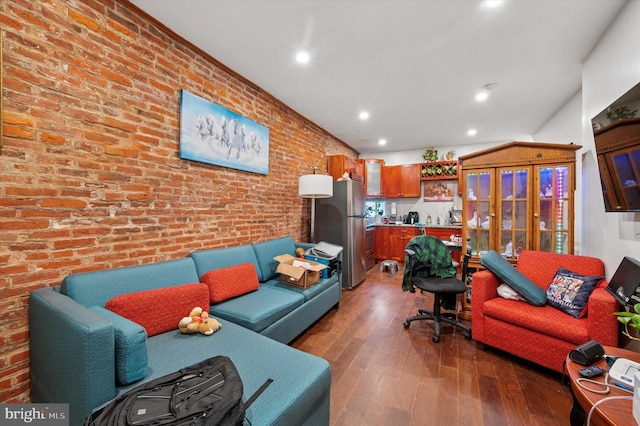 living room featuring recessed lighting, brick wall, and hardwood / wood-style floors