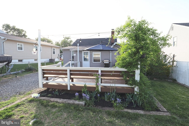 221 Arundel Rd, Pasadena, MD 21122 - rear view of house featuring a lawn, a wooden deck, and a fenced backyard