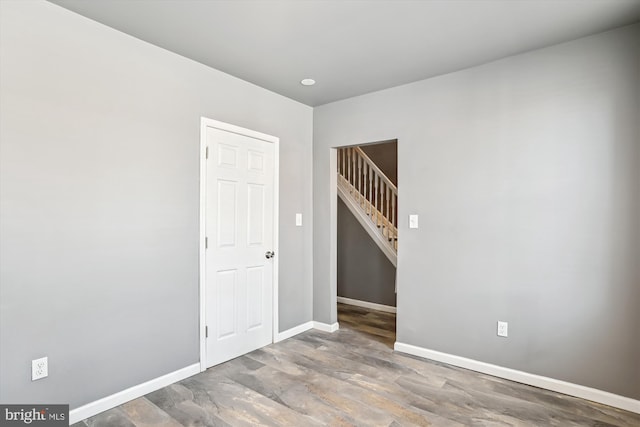 empty room featuring baseboards and wood finished floors