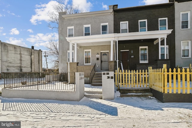 view of property with brick siding and a fenced front yard