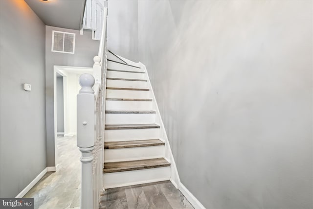 staircase featuring visible vents and baseboards