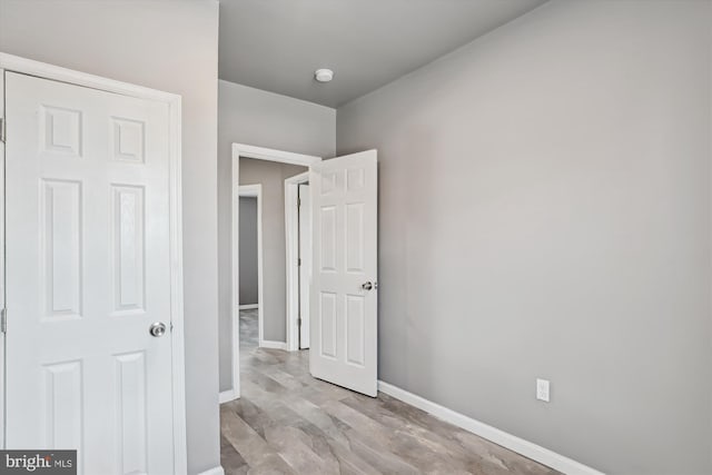 unfurnished bedroom featuring baseboards and light wood-style flooring