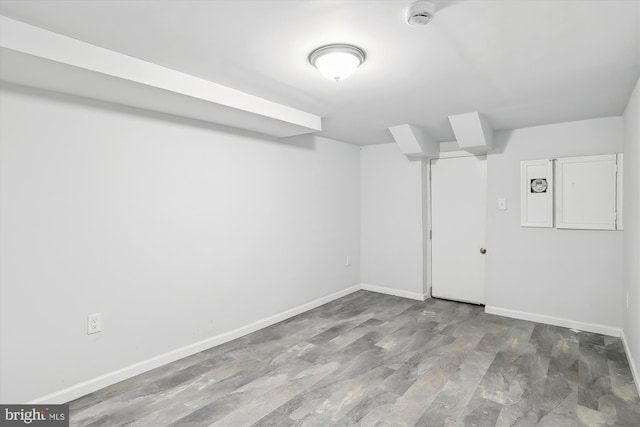 unfurnished room with baseboards