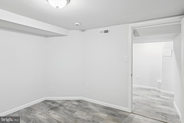 unfurnished room featuring visible vents and baseboards