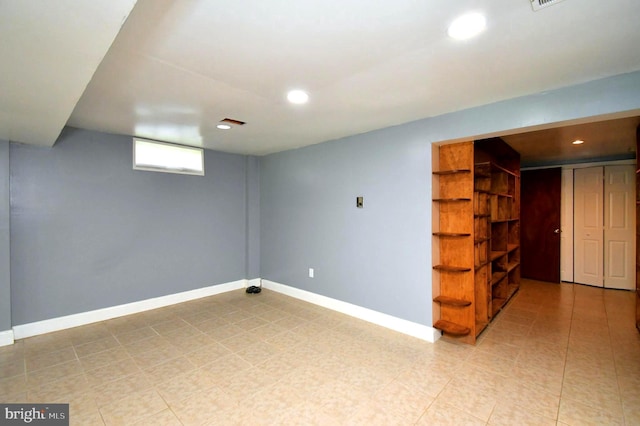 basement featuring recessed lighting and baseboards