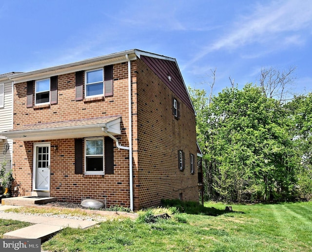 view of front of property with a front yard and brick siding