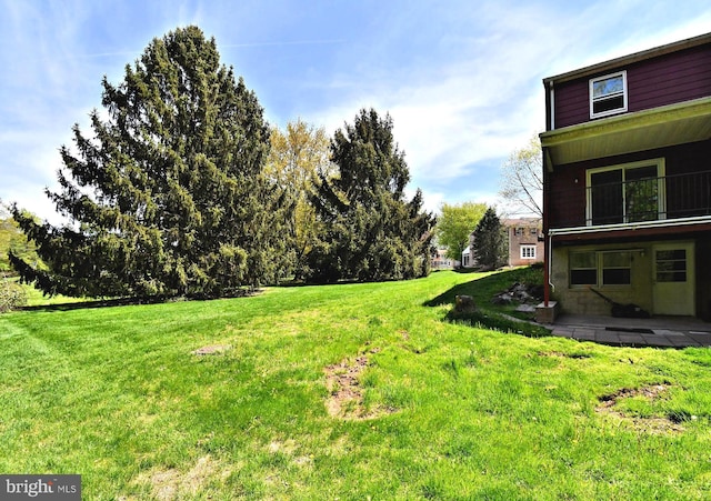 view of yard with a balcony and a patio area