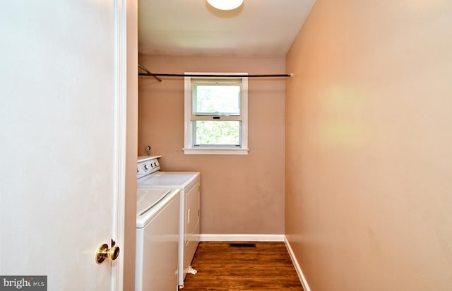 washroom featuring baseboards, laundry area, dark wood-style flooring, and washer and clothes dryer
