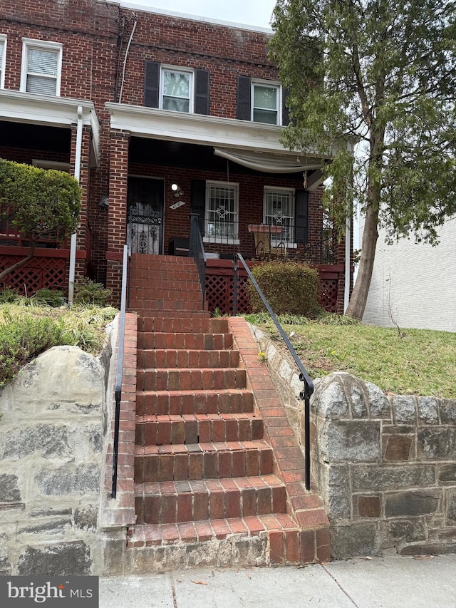 4710 12th St NE, Washington, DC 20006 - view of property featuring brick siding, a porch, and stairway