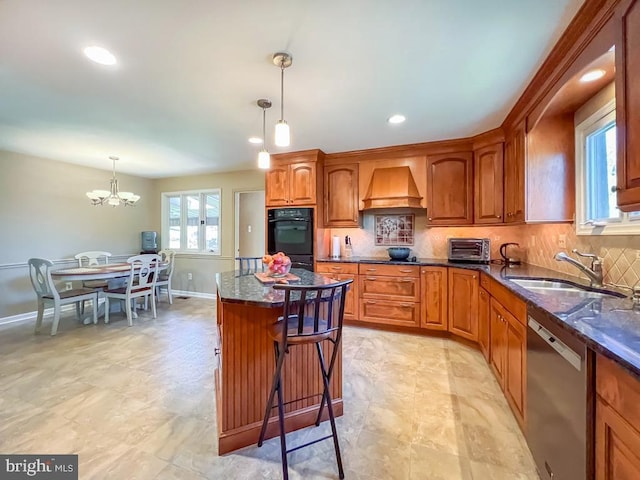 kitchen featuring a sink, dobule oven black, a chandelier, custom range hood, and stainless steel dishwasher