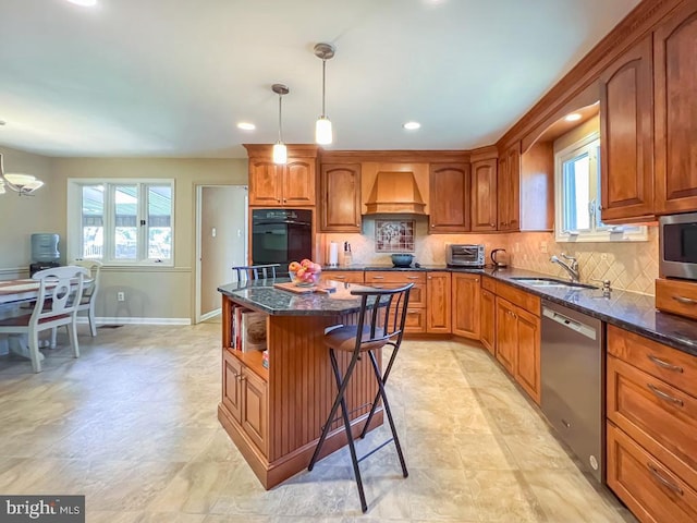 kitchen featuring a sink, appliances with stainless steel finishes, and brown cabinets