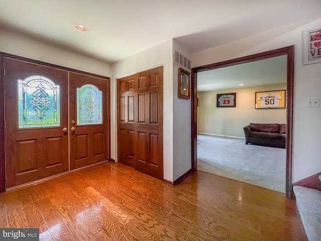 foyer featuring recessed lighting, visible vents, french doors, and wood finished floors