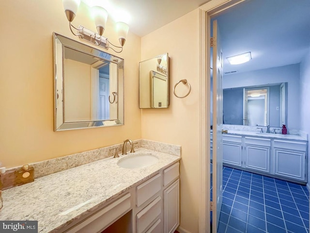 bathroom featuring tile patterned flooring and vanity
