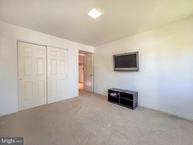 unfurnished bedroom featuring carpet floors and a closet
