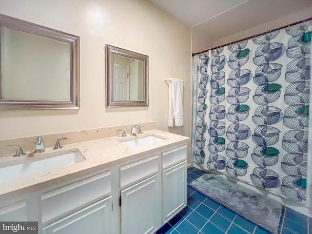 full bathroom featuring a sink, tile patterned floors, double vanity, and a shower with shower curtain