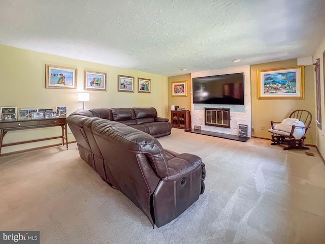 living area featuring a textured ceiling, baseboards, a glass covered fireplace, and carpet