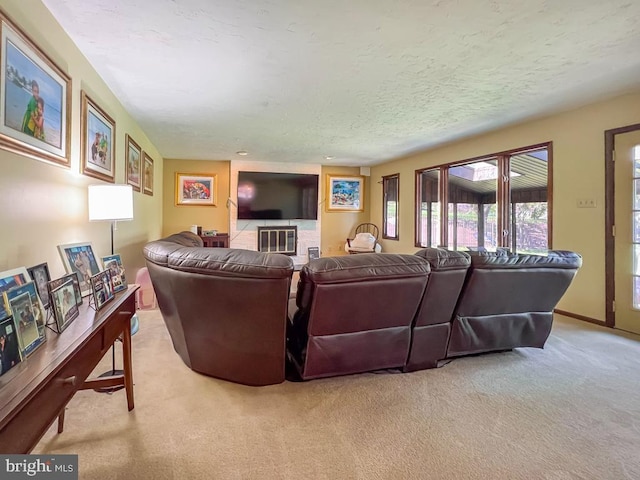 carpeted living room featuring a textured ceiling