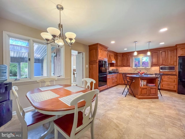 dining room featuring recessed lighting, an inviting chandelier, and a healthy amount of sunlight