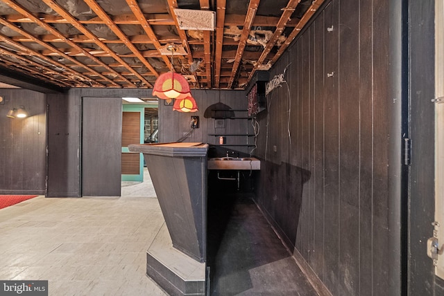 interior space featuring a dry bar and wood walls