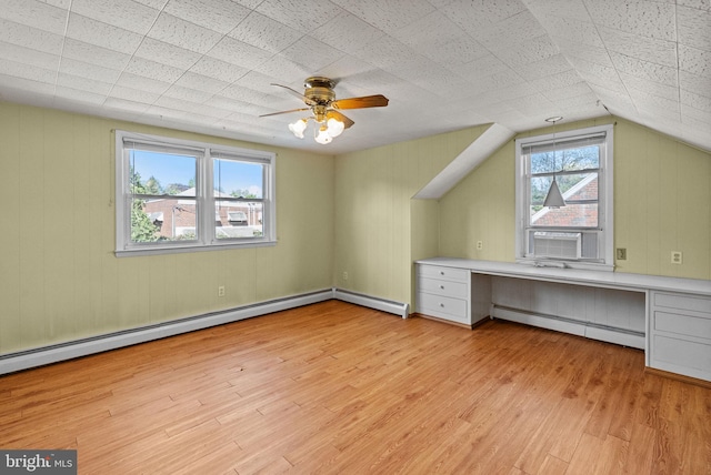 interior space featuring light wood-style floors, ceiling fan, and baseboard heating