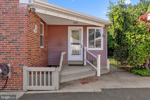 entrance to property featuring fence and a gate