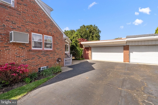 view of side of property with brick siding and a garage