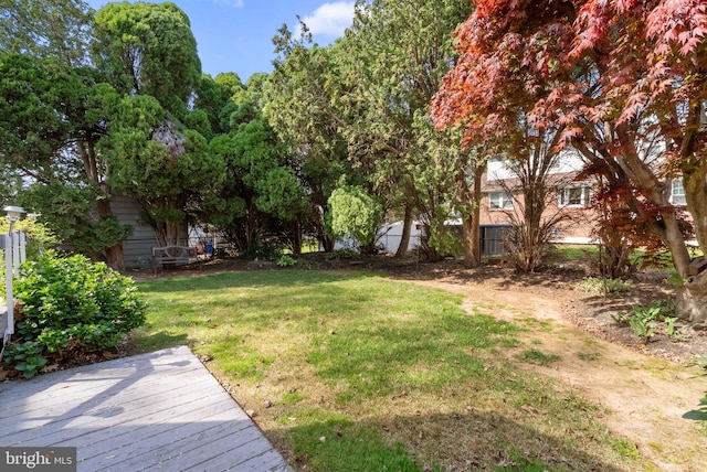 view of yard with fence and a wooden deck